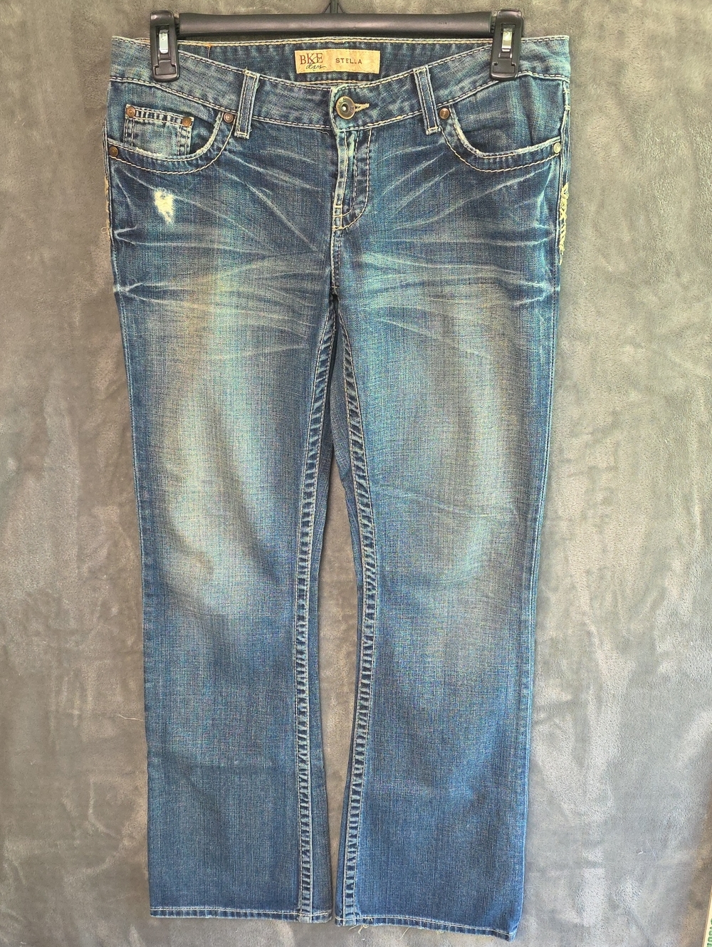 BKE Women's Distressed Boot Cut Leg Jeans in Faded Blue Wash
